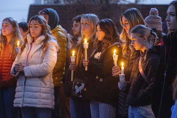 Boise State University students, along with people who knew the four University of Idaho students who were found killed in Moscow, Idaho, days earlier, pay their respects at a vigil held in front of a statue on the Boise State campus, Thursday, Nov. 17, 2022, in Boise, Idaho. 