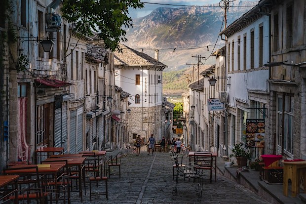 Gjirokaster, Albania  September 09, 2022: A beautiful alley in old town Gjirokaster on the background of the mountains, Albania