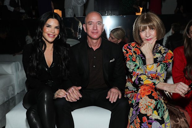 Lauren Sanchez, Jeff Bezos and Anna Wintour in the front row (Photo by John Salangsang/WWD/Penske Media via Getty Images)