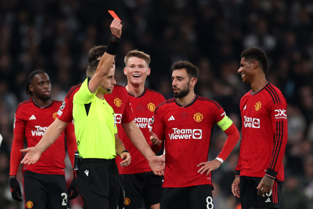 Marcus Rashford of Manchester United is shown a red card by referee Donatas Rumsas.