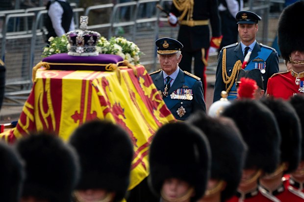 King Charles III and Prince William follow the coffin of Queen Elizabeth II, draped in the Royal Standard with the Imperial State Crown placed on top, carried on a horse-drawn gun carriage of the King's Troop Royal Horse Artillery, during the ceremonial procession from Buckingham Palace to Westminster Hall, London, Wednesday Sept. 14, 2022. 