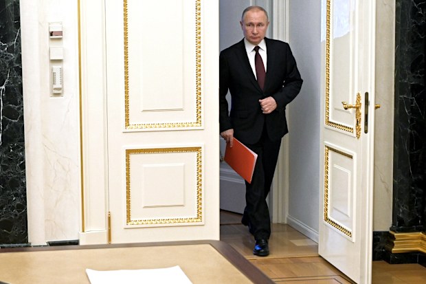  Russian President Vladimir Putin enters a hall to chair a Security Council meeting in Moscow, Russia, Friday, Feb. 25, 2022 
