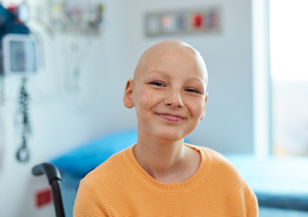 Bridgette smiles at the camera after losing her hair to chemotherapy and radiation.