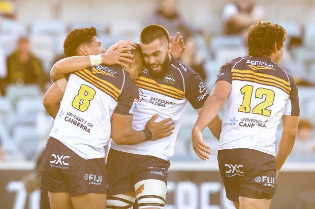 Brumbies players celebrate a try in Super Rugby Pacific.