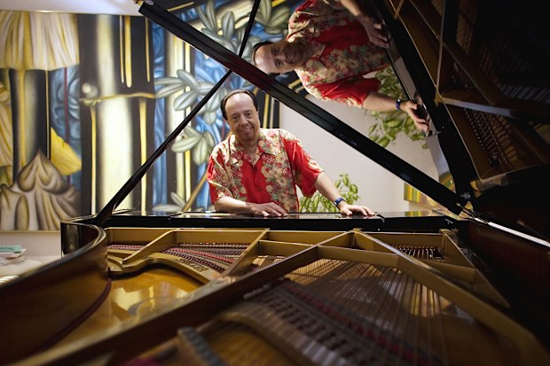FILE - Bossa Nova piano maestro Sergio Mendes sits for a portrait at his home in Woodland Hills, Calif., on Feb. 7, 2006. (AP Photo/Damian Dovarganes, File)