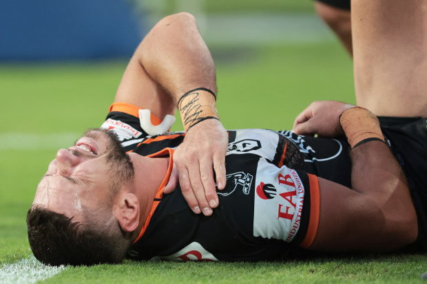  Brent Naden of the Wests Tigers lays on the field injured after scoring a try during the round six NRL match between Wests Tigers and Parramatta Eels at Accor Stadium on April 10, 2023 in Sydney, Australia. (Photo by Mark Metcalfe/Getty Images)