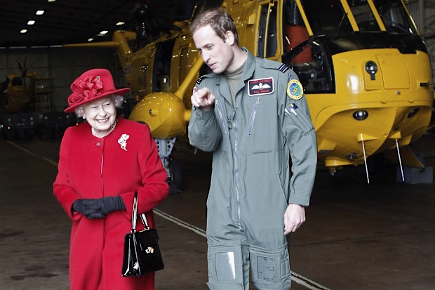 Britain's Queen Elizabeth II is escorted by Prince William, during a visit to RAF Valley, Anglesey, Wales, where he is stationed as a search and rescue helicopter pilot, Friday April 1, 2011. 