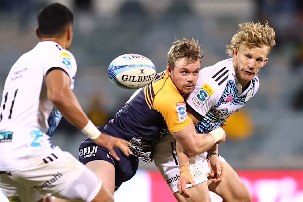 Damien McKenzie of the Chiefs offloads at GIO Stadium.
