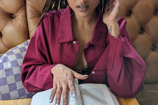 Woman reading a book at restaurant