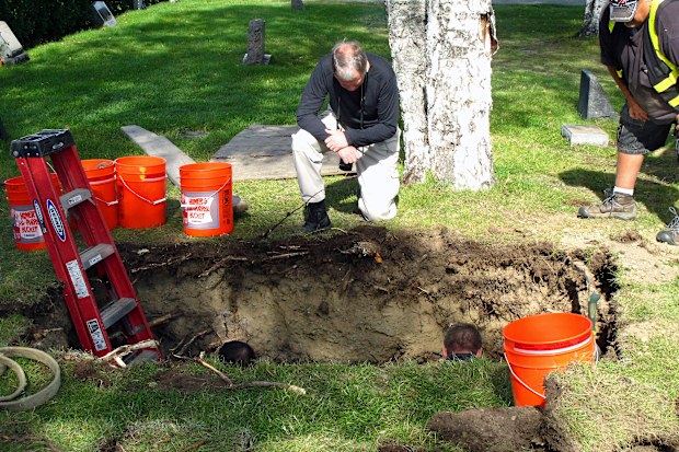 Workers and medical examiner crew members exhume the body of Jane Doe #3 from a cemetery in Anchorage, Alaska. (AP Photo/Rachel D'Oro, File)