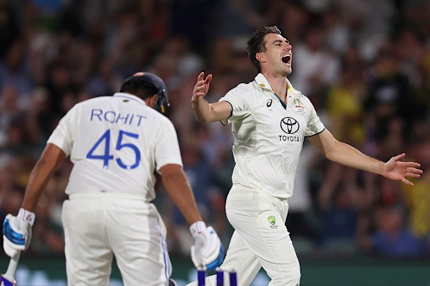 Pat Cummins of Australia celebrates after bowling Rohit Sharma.