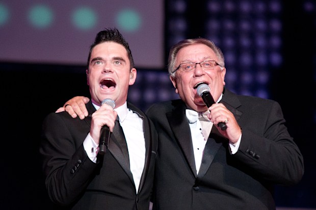 Robbie Williams and his dad Pete Conway perform at De Montfort Hall And Gardens on May 18, 2012 in Leicester, United Kingdom.