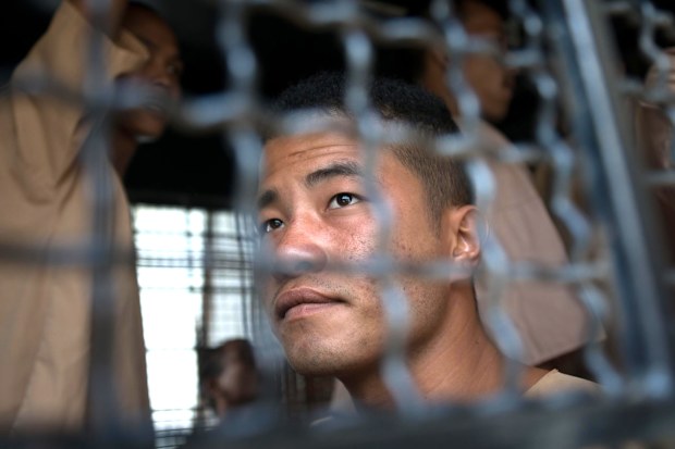 Myanmar national Zaw Lin arrives in a prison transport van outside Koh Samui court in Thailand on July 9, 2015. Lin had been found guilty and sentenced to death.