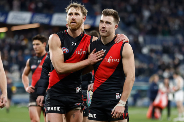 GEELONG, AUSTRALIA - JULY 15: Dyson Heppell (left) and Zach Merrett of the Bombers look dejected after a loss during the 2023 AFL Round 18 match between the Geelong Cats and the Essendon Bombers at GMHBA Stadium on July 15, 2023 in Geelong, Australia. (Photo by Michael Willson/AFL Photos via Getty Images)