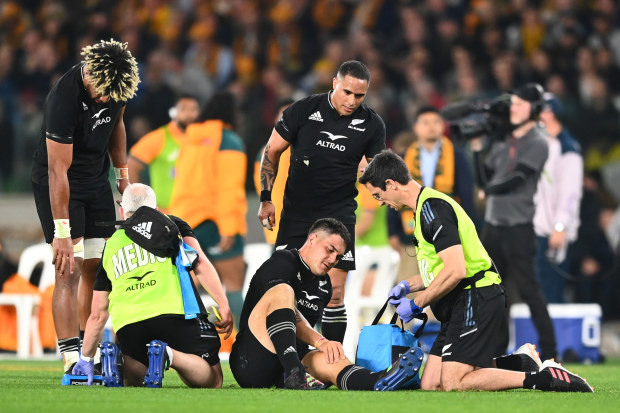 Quinn Tupaea of the All Blacks receives medical attention.