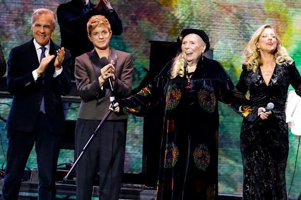 HAMILTON, ONTARIO - MARCH 29: (L-R) William Prince, Prime Minister of Canada Mark Carney, Mae Martin, Joni Mitchell, Sarah McLachlan, Allison Russell and Jully Black perform onstage during the 2026 JUNO Awards at TD Coliseum on March 29, 2026 in Hamilton, Ontario. (Photo by Cindy Ord/Getty Images)