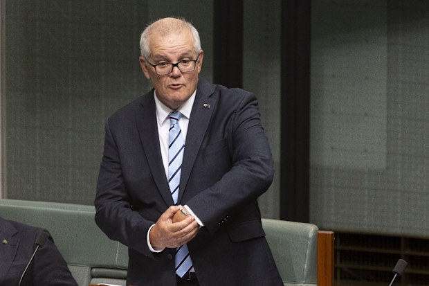 Former Prime Minister Scott Morrison points out his "ScoMo" Taylor Swift friendship bracelet during his valedictory speech