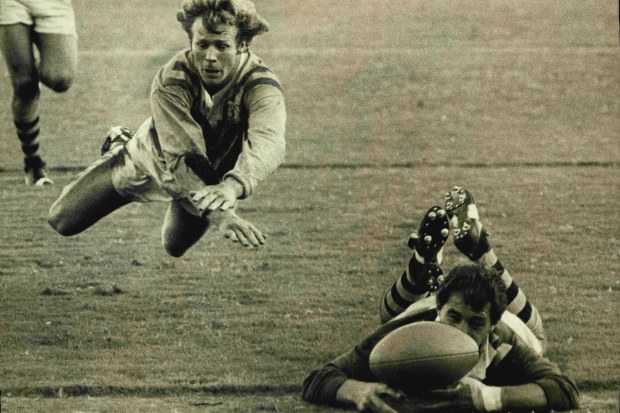 Sydney Firsts centre Bob Fulton looks aggrieved that his airborne attempted tackle is too late to stop Country half-back Brian Burke's disputed try in the Rugby League match at the SCG yesterday. May 19, 1973. (Photo by John Patrick O'Gready/Fairfax Media).