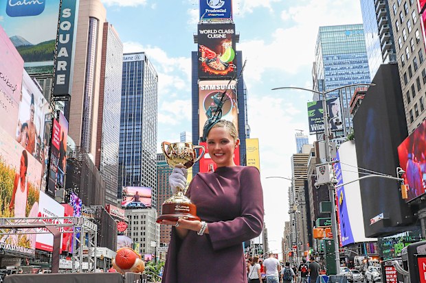 Georgina Burke in Times Square holding the Lexus Melbourne Cup Trophy.