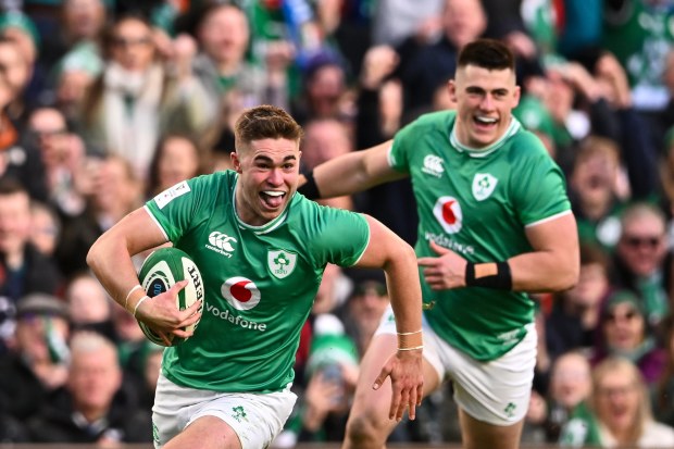 Jack Crowley (left) of Ireland runs in to score his side's first try during the Six Nations against Italy.