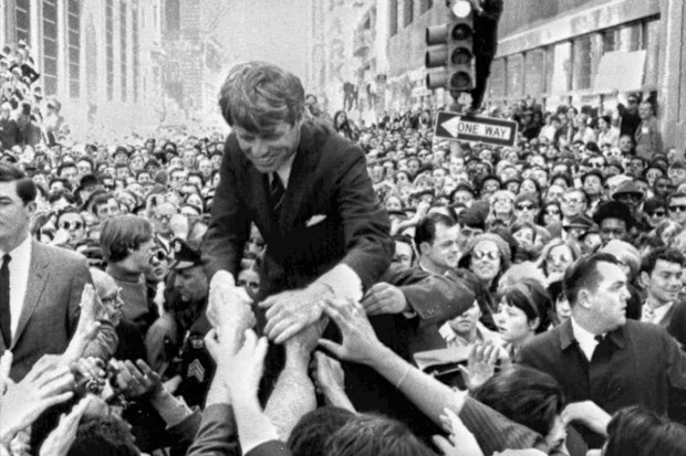 In this April 2, 1968 file photo U.S. Sen. Robert F. Kennedy, D-NY, shakes hands with people in a crowd while campaigning for the Democratic party's presidential nomination on a street corner, in Philadelphia