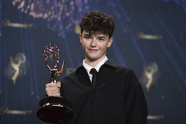 Owen Cooper, winner of the award for outstanding supporting actor in a limited or anthology series or movie for "Adolescence," poses in the press room during the 77th Primetime Emmy Awards on Sunday, Sept. 14, 2025, at the Peacock Theater in Los Angeles. 