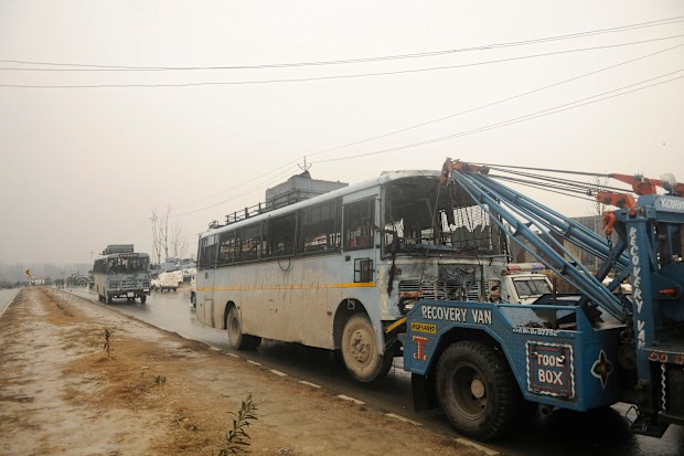A crane drags a damaged vehicle 