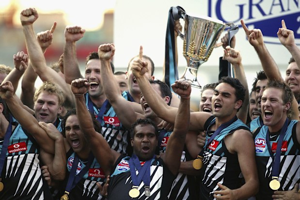 MELBOURNE, AUSTRALIA - SEPTEMBER 25:   Port Adelaide celebrate with the cup after the AFL Grand Final between the Port Adelaide Power and the Brisbane Lions at the Melbourne Cricket Ground September 25, 2004 in Melbourne, Australia. (Photo by Tony Lewis/Getty Images)