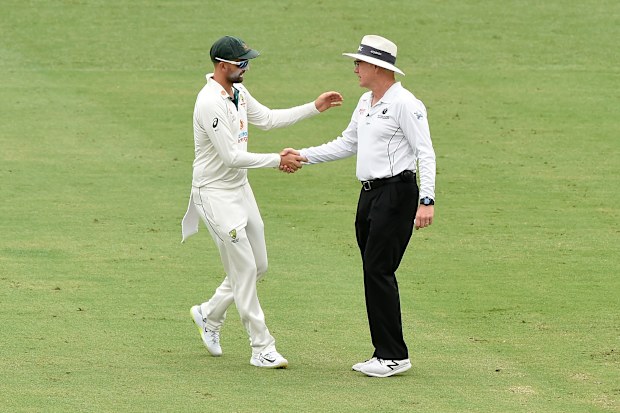 Nathan Lyon of Australia shakes hands with umpire Bruce Oxenford.