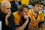 Dejected Wallabies Nathan Sharpe, Bill Young and David Lyons watch England celebrate in 2003.
