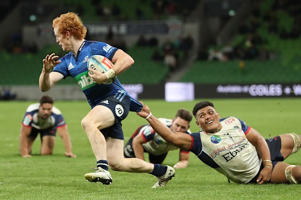 Finlay Christie of the Blues on the way to scoring a try.