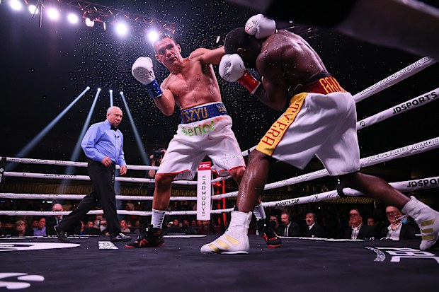MINNEAPOLIS, MN - MARCH 26: Tim Tszyu (white with blue trunks) v Terrell Gausha (white with red and gold trunks) box in the Super Welterweight main event at the Armory on March 26, 2022 in Minneapolis, United States. Tszyu, in his USA debut defeated Gausha by judges decision. (Photo by Adam Bettcher/Getty Images)