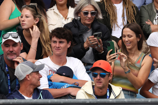 Bec Hewitt takes a photo of Lleyton Hewitt as they watch their son Cruz on debut in the Australian Open juniors tournament.