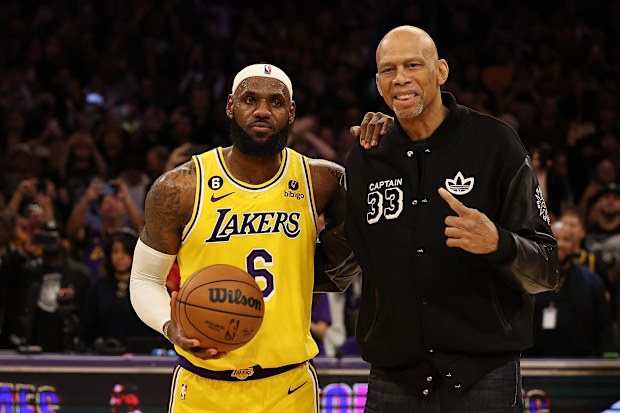 LOS ANGELES, CALIFORNIA - FEBRUARY 07: Kareem Abdul-Jabbar stands on court with LeBron James #6 of the Los Angeles Lakers after James passed Abdul-Jabbar to become the NBA's all-time leading scorer, surpassing Abdul-Jabbar's career total of 38,387 points against the Oklahoma City Thunder at Crypto.com Arena on February 07, 2023 in Los Angeles, California. NOTE TO USER: User expressly acknowledges and agrees that, by downloading and or using this photograph, User is consenting to the terms and co