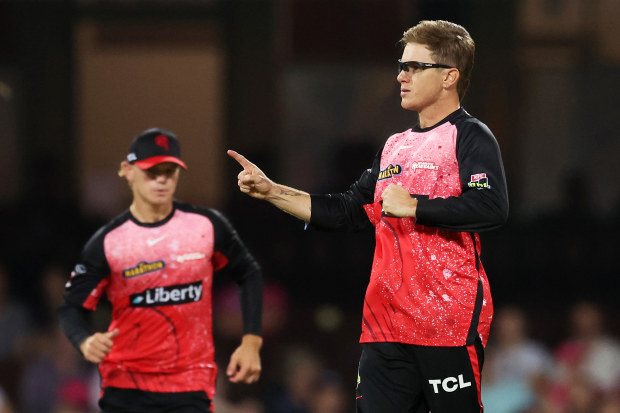 Adam Zampa of the Renegades celebrates with teammates after taking the wicket of Tom Curran of the Sixers.