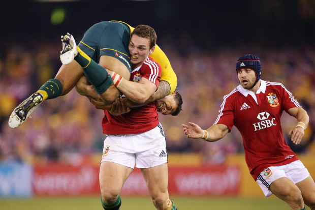George North of the Lions lifts Israel Folau while carrying the ball during game two of the 2013 Test series against the Wallabies in Melbourne.
