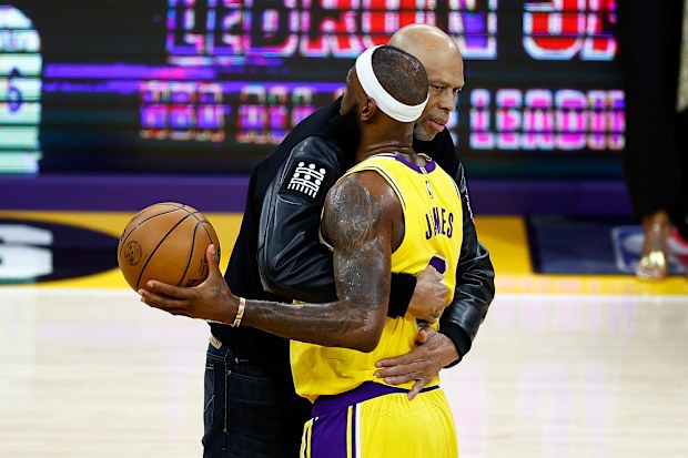 LOS ANGELES, CALIFORNIA - FEBRUARY 07: Kareem Abdul-Jabbar ceremoniously hands LeBron James #6 of the Los Angeles Lakers the ball after James passed Abdul-Jabbar to become the NBA's all-time leading scorer, surpassing Abdul-Jabbar's career total of 38,387 points against the Oklahoma City Thunder at Crypto.com Arena on February 07, 2023 in Los Angeles, California. NOTE TO USER: User expressly acknowledges and agrees that, by downloading and or using this photograph, User is consenting to the term