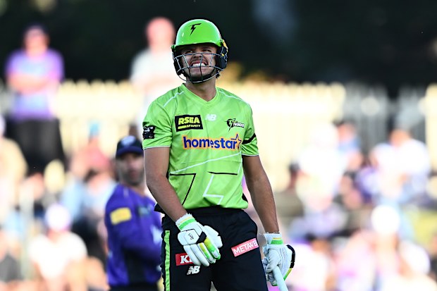 HOBART, AUSTRALIA - DECEMBER 16: Sam Konstas of the Thunder reacts after he is struck by a delivery during the BBL match between Hobart Hurricanes and Sydney Thunder at Ninja Stadium, on December 16, 2025, in Hobart, Australia (Photo by Steve Bell/Getty Images)