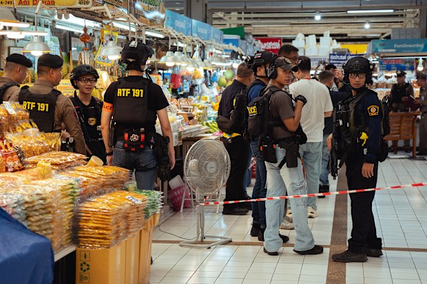 Police monitoring the cordoned area in Or Tor Kor market on July 28, 2025 in Bangkok, Thailand, after an active shooter situation