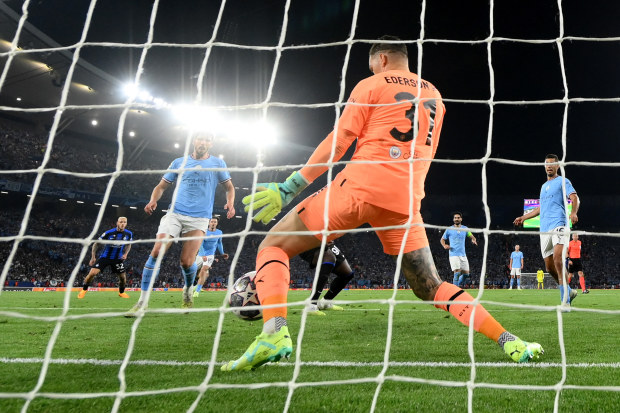 Manchester City goalkeeper Ederson makes a  crucial save.