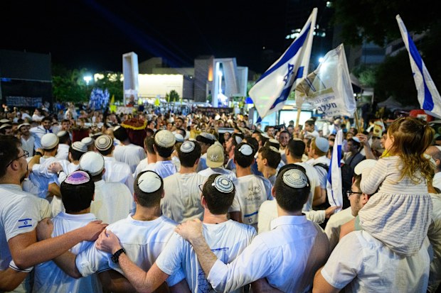 Israel has received a coffin carrying the body of a deceased hostage, the prime minister's office said in a statement late Friday. In this October 14 photo, people celebrated in Tel Aviv's Hostages Square after the announcement that bodies of four Israeli hostages would be released.
