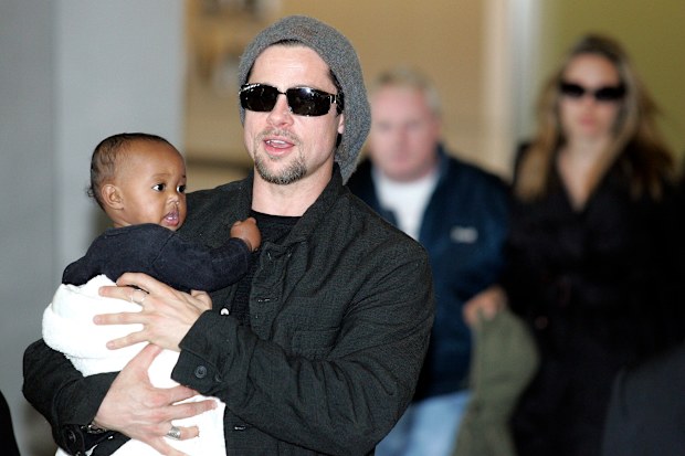 Brad Pitt followed by actress Angela Jolie arrive at the New Tokyo International Airport on November 27, 2005 in Narita, Japan. They are in Japan to promote a film "Mr. and Mrs. Smith". 
