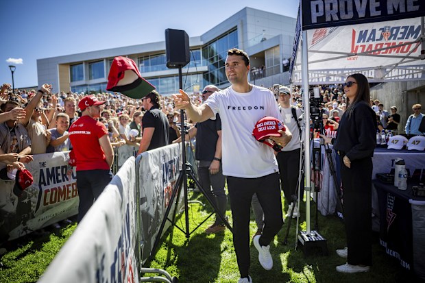 Charlie Kirk hands out hats before speaking at Utah Valley University in Orem, Utah, Wednesday, Sept. 10, 2025. (Tess Crowley/The Deseret News via AP)