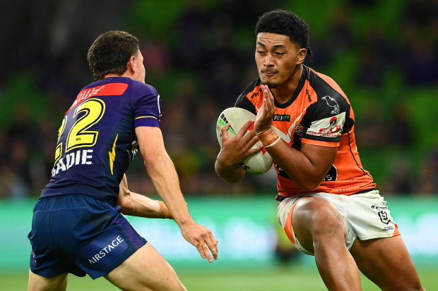 MELBOURNE, AUSTRALIA - MARCH 24:  Junior Tupou of the Tigers is tackled by Jonah Pezet of the Storm during the round four NRL match between the Melbourne Storm and Wests Tigers at AAMI Park on March 24, 2023 in Melbourne, Australia. (Photo by Quinn Rooney/Getty Images)