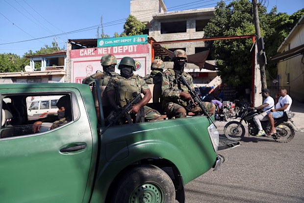 Members of the Haitian Armed Forces patrol as people flee homes following the gang violence over the weekend in Port-au-Prince.