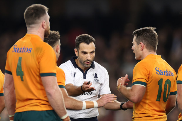 Referee Mathieu Raynal speaks to the Wallabies.