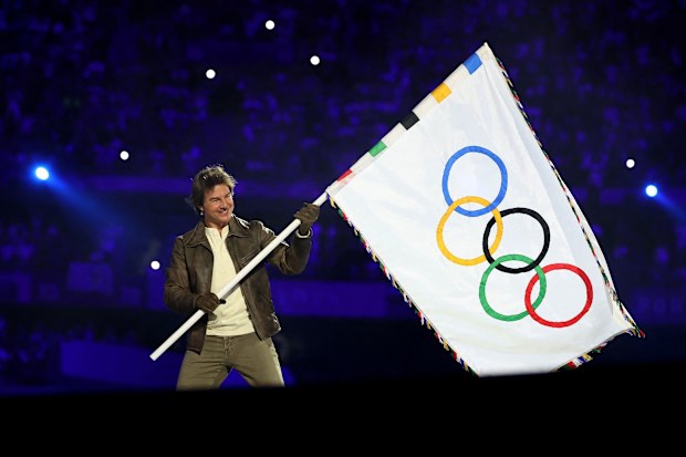 Tom Cruise holds the Olympic flag during the Closing Ceremony of the Olympic Games Paris 2024 at Stade de France on August 11