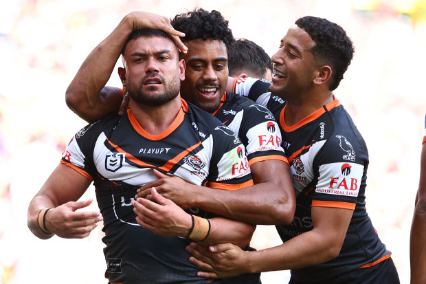 David Nofoaluma of the Wests Tigers celebrates with teammates after scoring a try against the St George Illawarra Dragons.