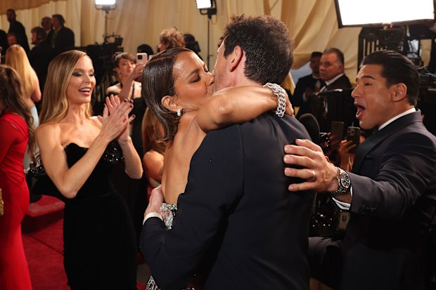 	Halle Berry swooped in for a surprise smooch with 2025 Oscar nominee Adrien Brody on the Oscars red carpet, to the delight of Brody's girlfriend Georgina Chapman (left) and shock of Mario Lopez (right). 	Halle Berry swooped in for a surprise smooch with 2025 Oscar nominee Adrien Brody on the Oscars red carpet, to the delight of Brody's girlfriend Georgina Chapman (left) and shock of Mario Lopez (right).