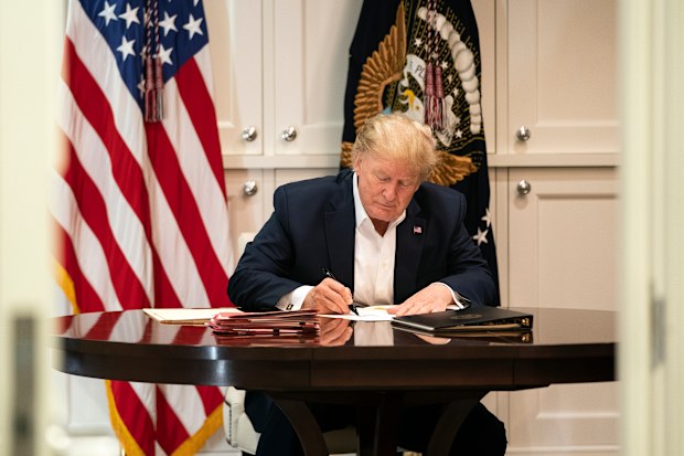 In this image released by the White House, President Donald Trump works in the Presidential Suite at Walter Reed National Military Medical Centre. (Joyce N. Boghosian/The White House via AP)